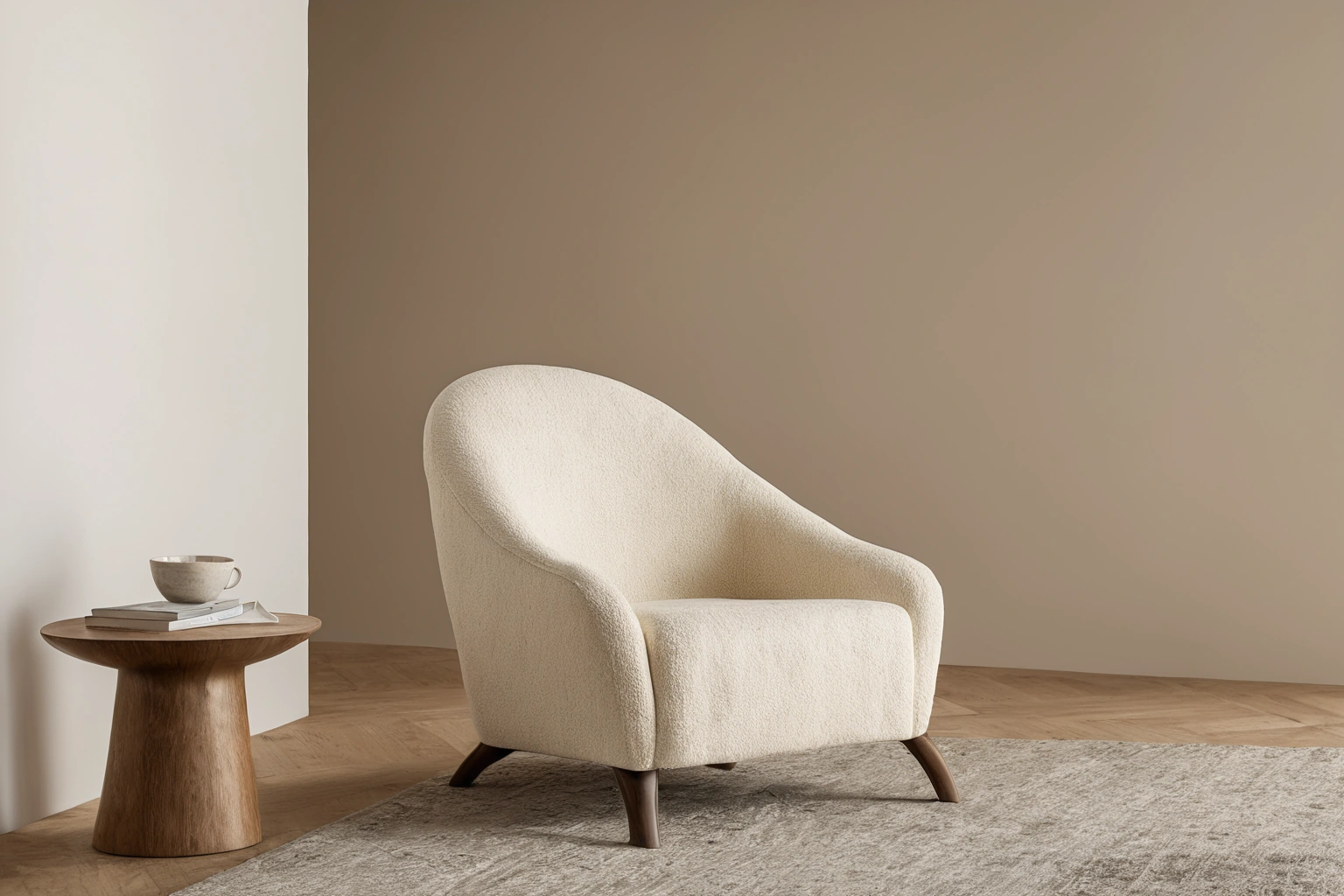 Curved armchair upholstered in cream boucl&eacute; fabric in a calm interior